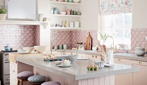 Light pink tiled kitchen splashback and white island unit